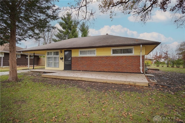 rear view of property with a yard