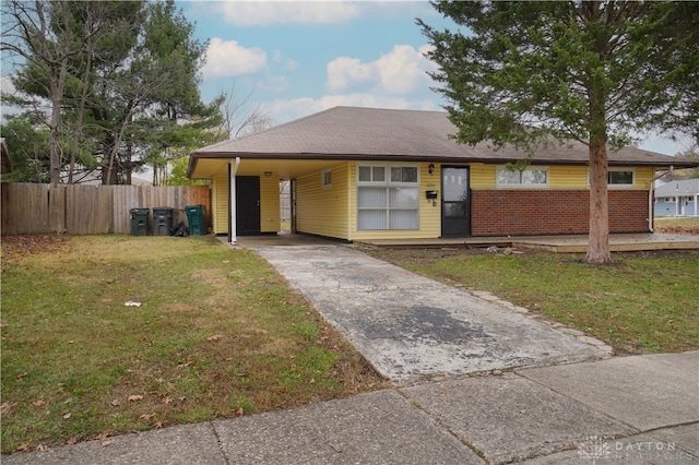 ranch-style house with a front yard and a carport