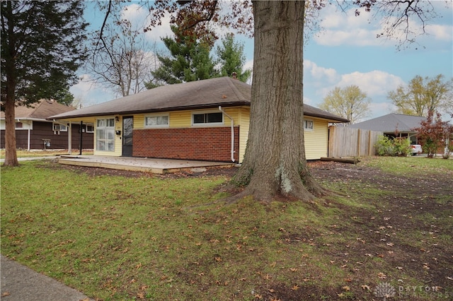 rear view of property with a lawn and a patio area