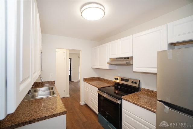 kitchen with white cabinets, dark hardwood / wood-style flooring, stainless steel appliances, and extractor fan