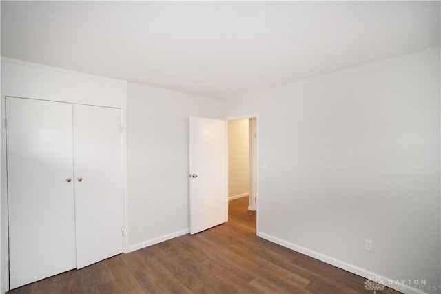 unfurnished bedroom featuring hardwood / wood-style flooring and a closet