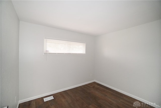 empty room featuring dark hardwood / wood-style flooring