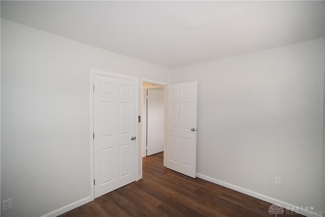 empty room featuring dark wood-type flooring