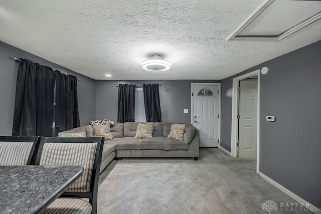 carpeted living room with a textured ceiling