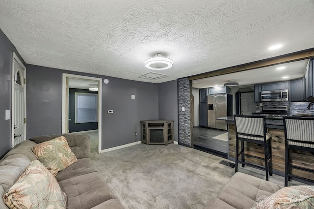 carpeted living room with a textured ceiling and sink