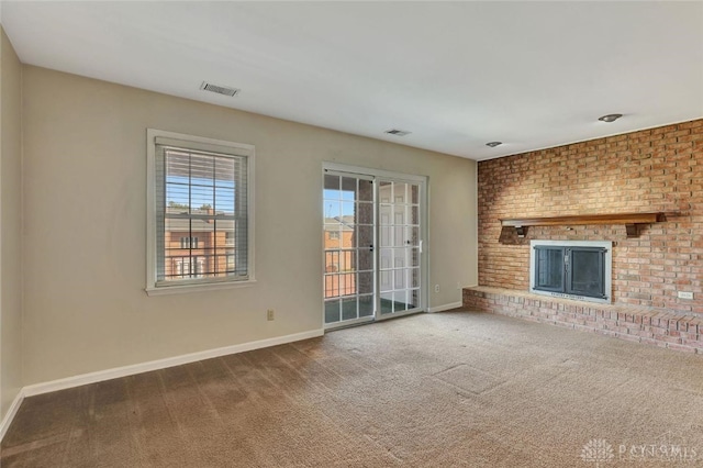 unfurnished living room featuring a fireplace and carpet floors