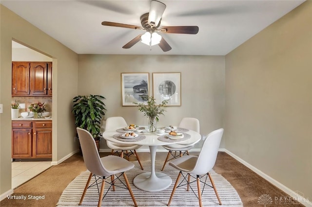 carpeted dining space featuring ceiling fan