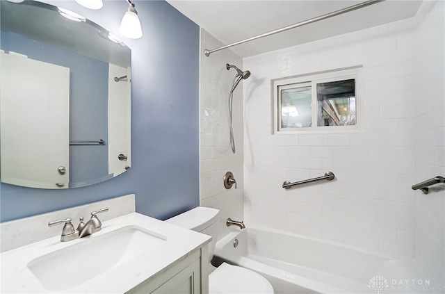 full bathroom featuring vanity, toilet, and tiled shower / bath