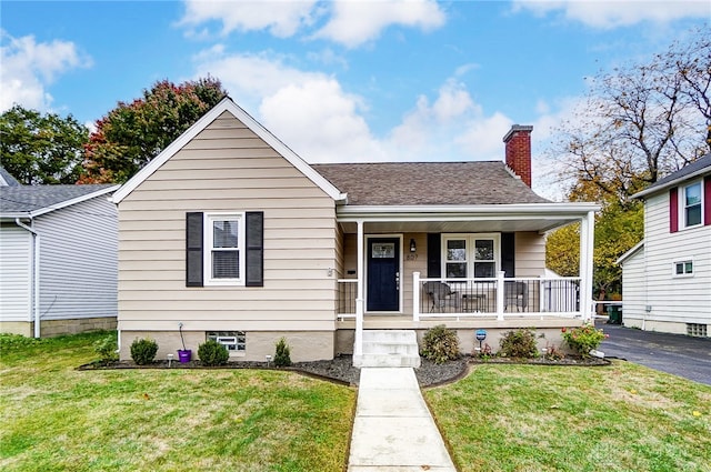 bungalow-style house with a front lawn and a porch