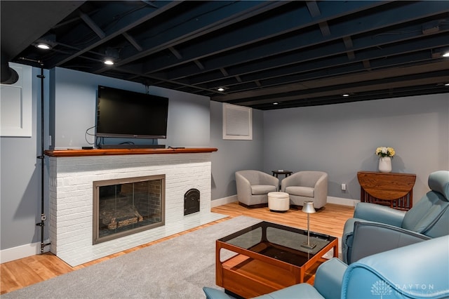 living room featuring wood-type flooring and a fireplace