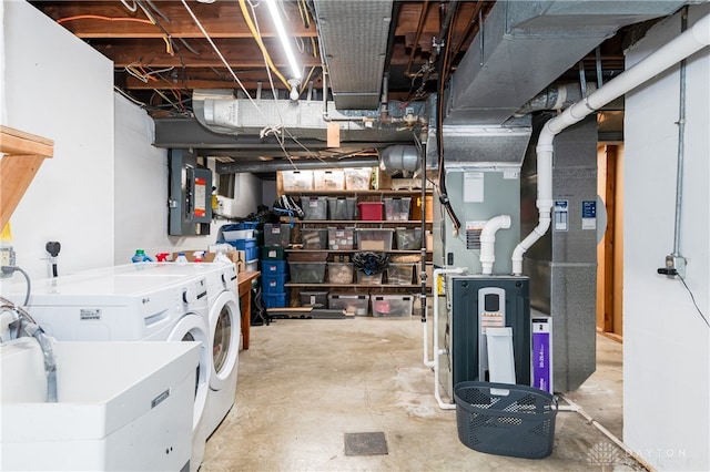 basement with washer and dryer, sink, electric panel, and heating unit