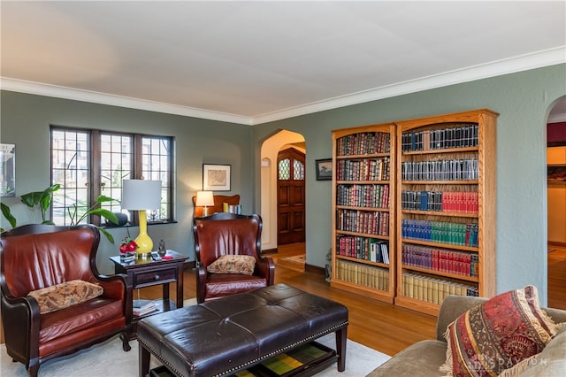 sitting room with crown molding and hardwood / wood-style floors