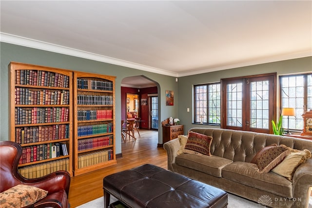 living room featuring light hardwood / wood-style flooring, french doors, and ornamental molding