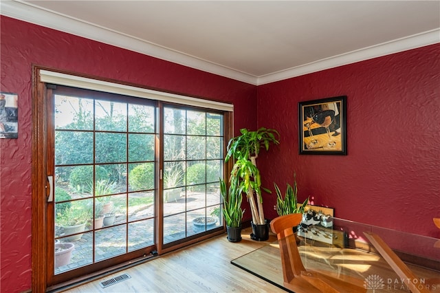 entryway featuring hardwood / wood-style floors and ornamental molding