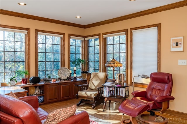 sitting room featuring light wood-type flooring and ornamental molding