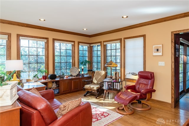 sitting room with light hardwood / wood-style floors and ornamental molding