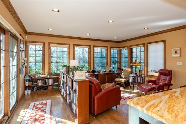 living room with hardwood / wood-style flooring and ornamental molding