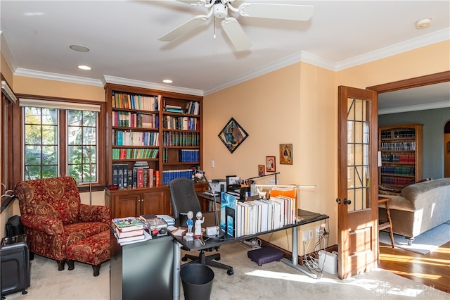 carpeted office space featuring ceiling fan and ornamental molding