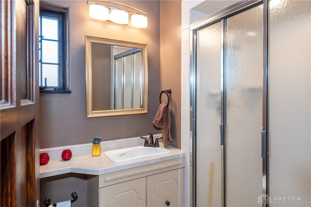 bathroom featuring vanity and an enclosed shower