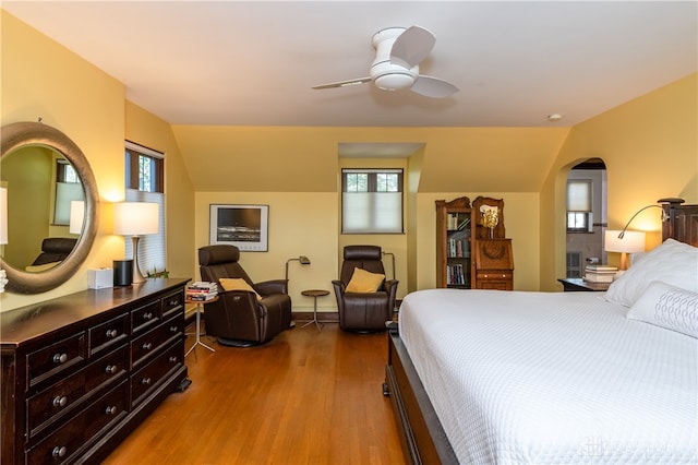 bedroom with multiple windows, wood-type flooring, vaulted ceiling, and ceiling fan