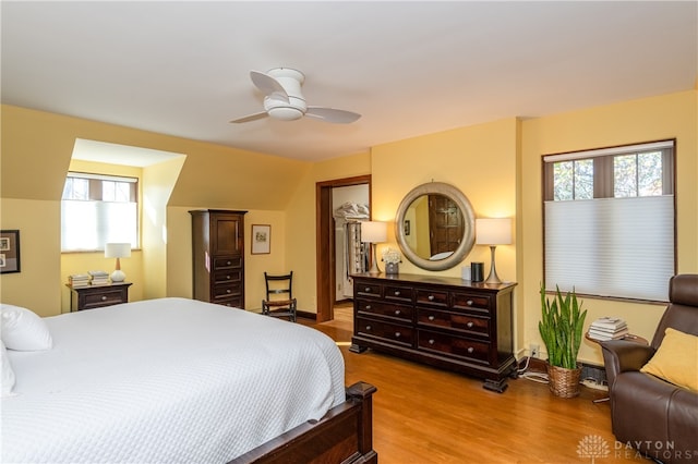 bedroom with hardwood / wood-style floors, ceiling fan, and lofted ceiling