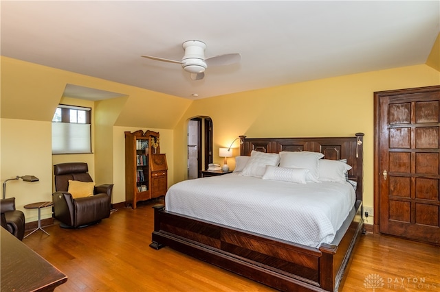 bedroom with hardwood / wood-style flooring, ceiling fan, and lofted ceiling