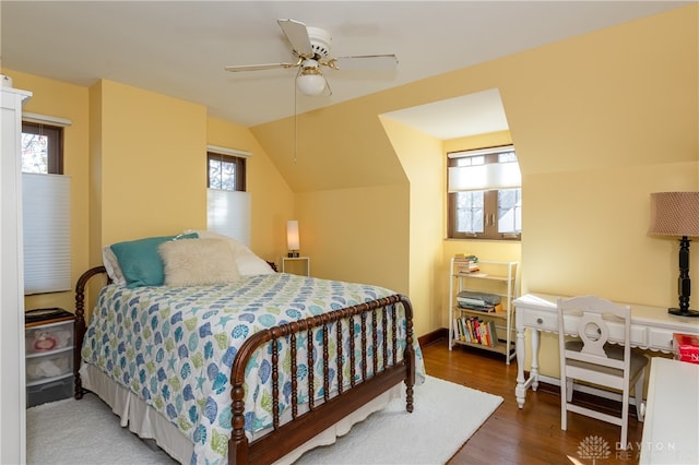 bedroom featuring ceiling fan, lofted ceiling, and dark wood-type flooring