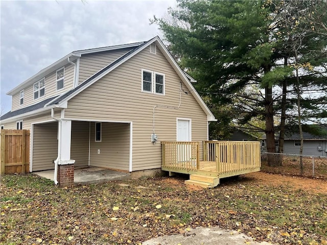 rear view of property with a wooden deck