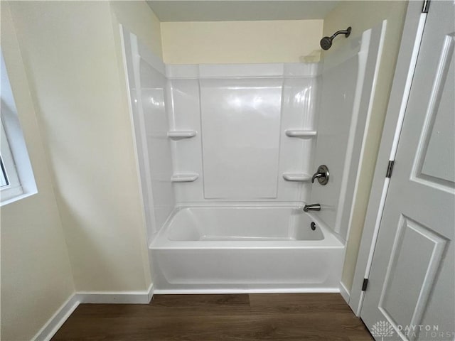 bathroom featuring hardwood / wood-style flooring and shower / bathtub combination