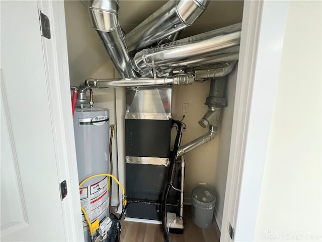 utility room featuring water heater