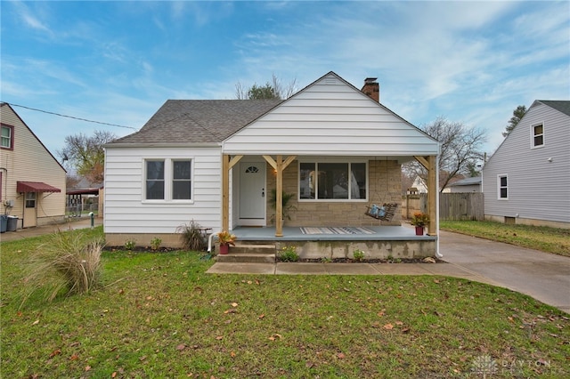 bungalow-style house with a porch and a front yard