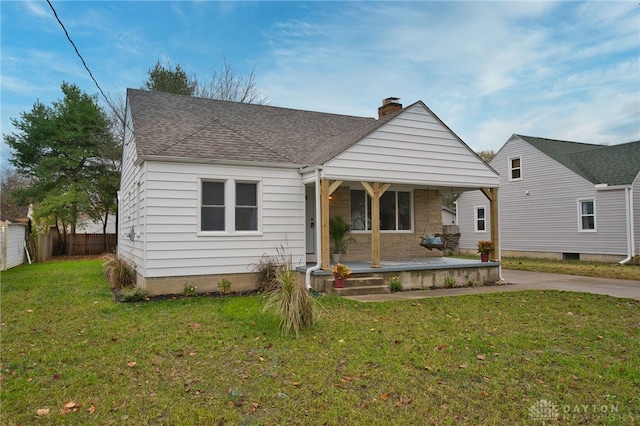 bungalow with a front yard and a porch