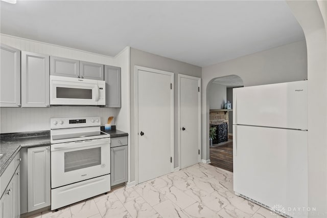 kitchen featuring gray cabinetry and white appliances