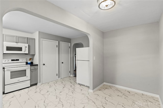 kitchen featuring gray cabinetry and white appliances