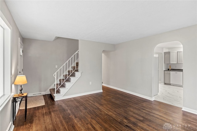 unfurnished living room featuring dark wood-type flooring