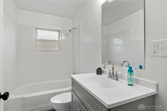 full bathroom with vanity, toilet, and tiled shower / bath combo