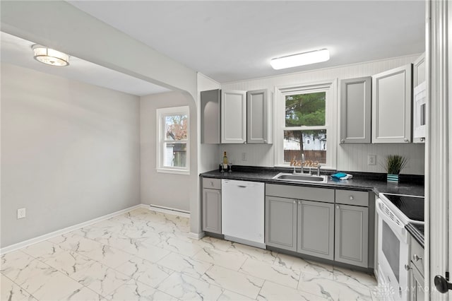 kitchen featuring white appliances, gray cabinets, plenty of natural light, and sink