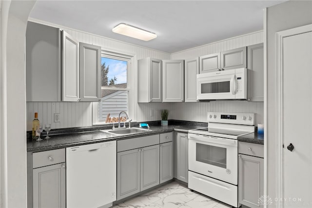 kitchen with gray cabinetry, sink, and white appliances