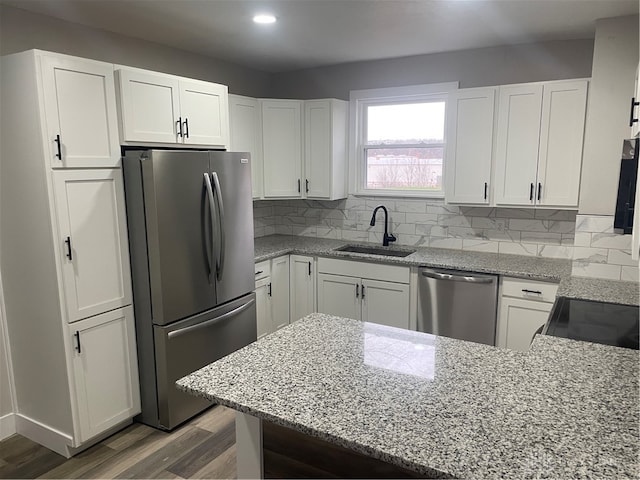 kitchen featuring white cabinets, appliances with stainless steel finishes, and sink