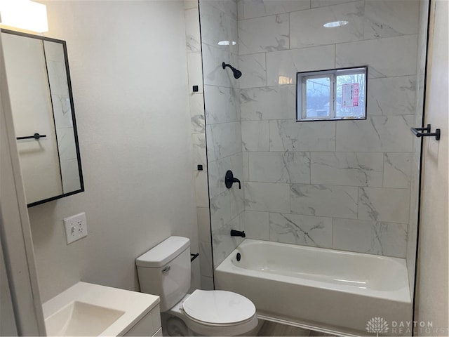 full bathroom with vanity, toilet, and tiled shower / bath combo