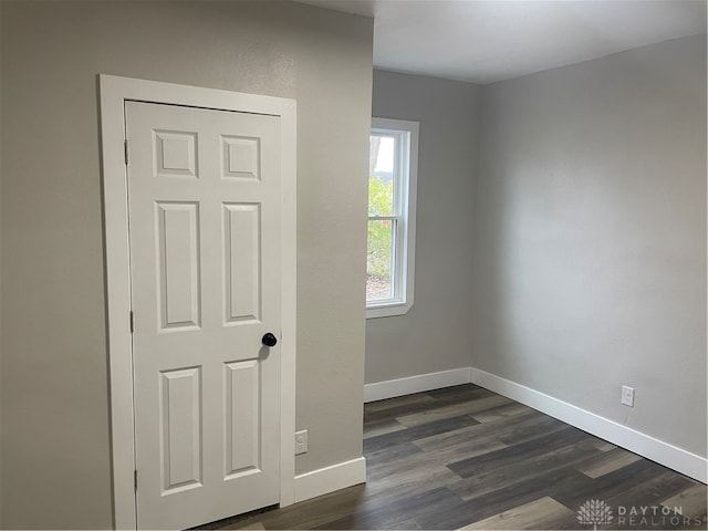 spare room featuring dark hardwood / wood-style floors