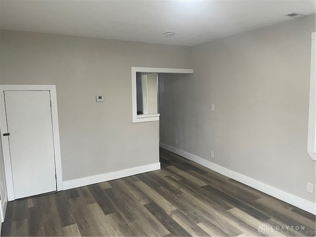 spare room featuring dark hardwood / wood-style flooring