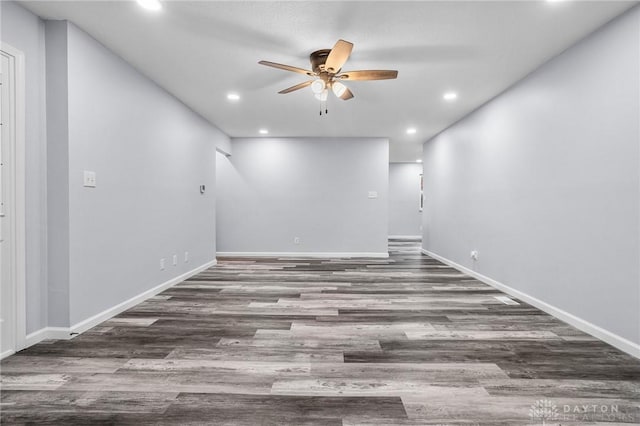 unfurnished room featuring dark wood-type flooring and ceiling fan