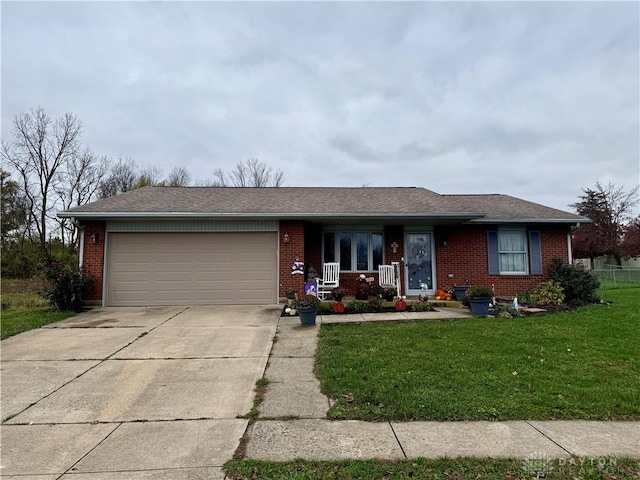 ranch-style home with a garage and a front lawn