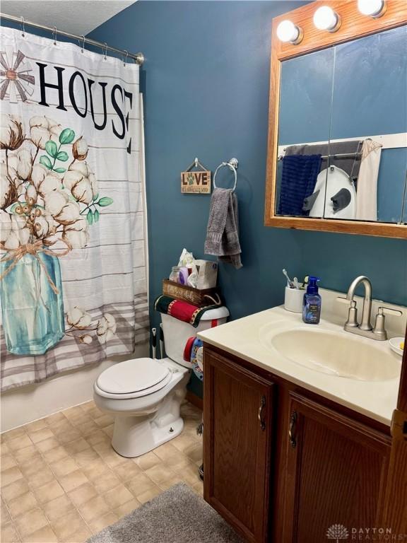 bathroom featuring vanity, toilet, and walk in shower