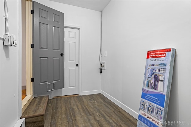 hall featuring baseboard heating and dark wood-type flooring