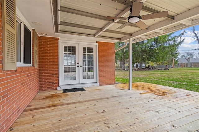 deck featuring french doors, a yard, and ceiling fan