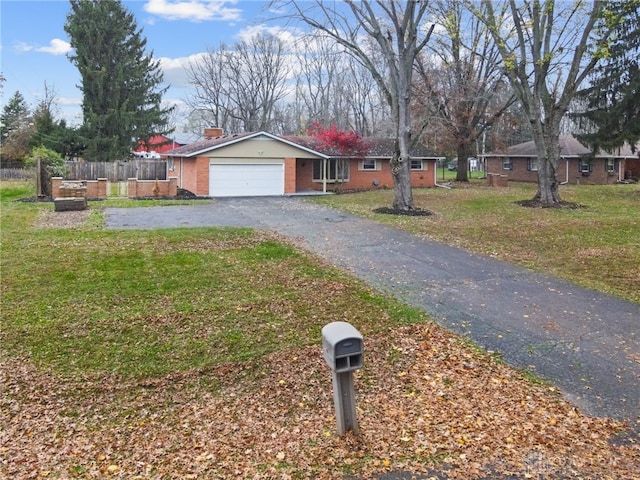 view of front of home featuring a front yard and a garage