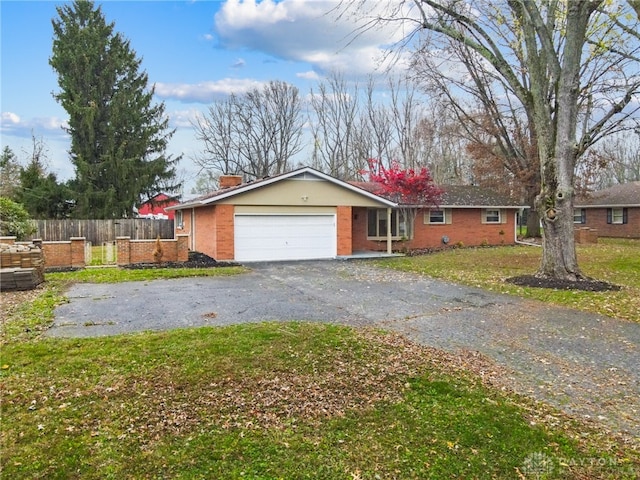 single story home with a garage and a front yard