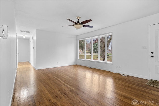 unfurnished living room featuring hardwood / wood-style flooring and ceiling fan